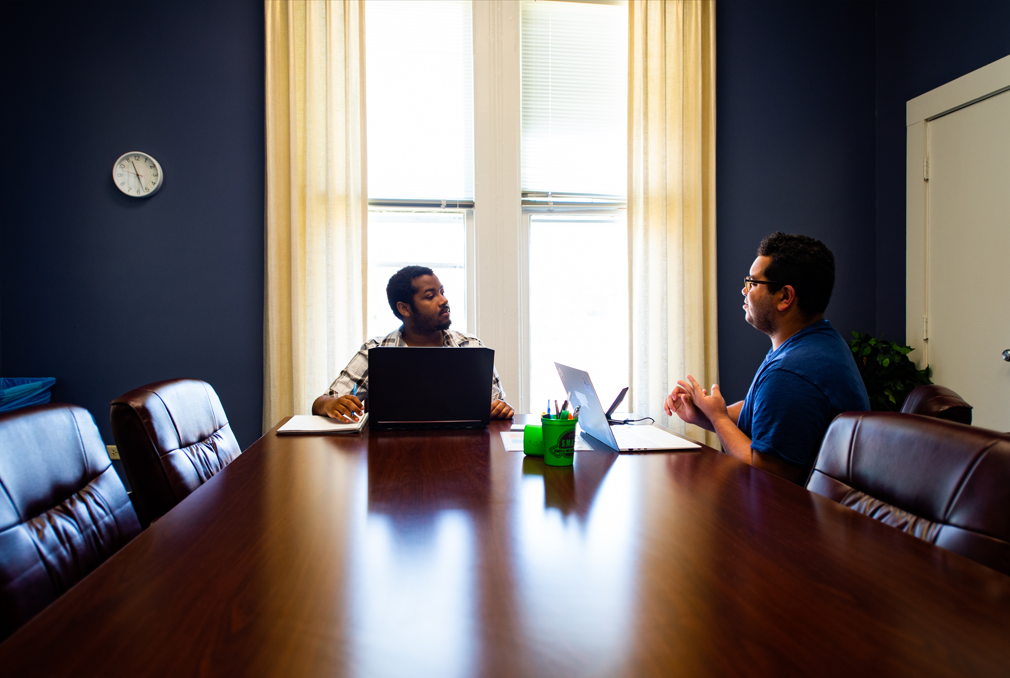 Consultant Discusses Writing with Writer in the Conference Room